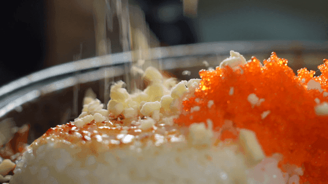 Rice topped with flying fish roe and cheese