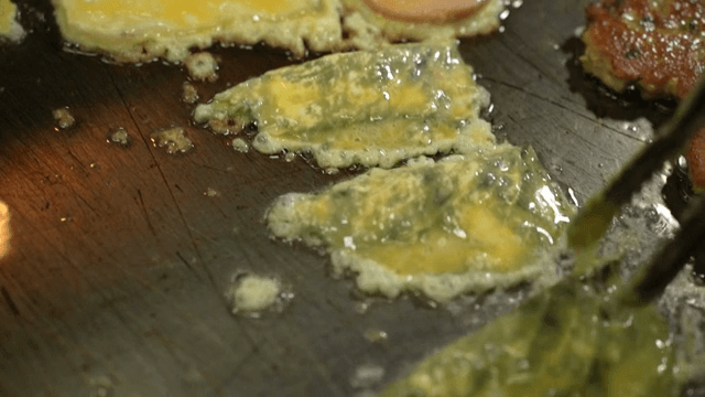 Korean pancakes frying on a hot pan