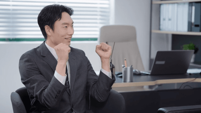 정장을 입은 남자가 파이팅을 외치는 모습