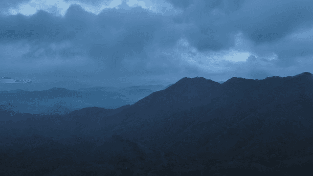 Misty mountains under a cloudy sky