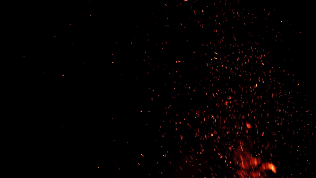 Sparks flying from campfire at night