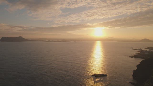 Sunset over the ocean with distant islands