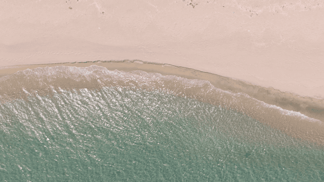 Waves gently lapping on a sandy beach