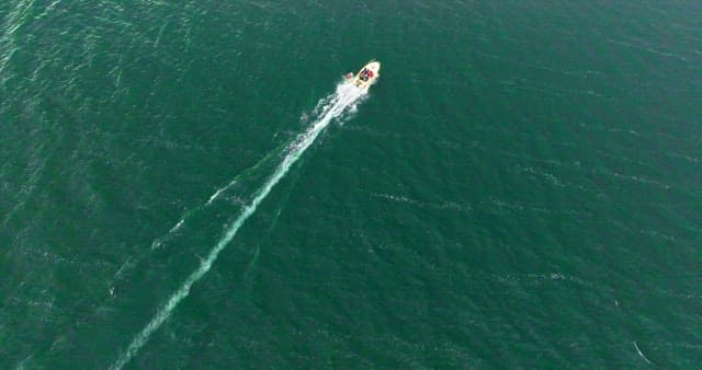 Boat speeding across the open sea