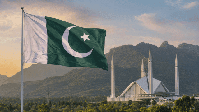 Pakistani flag fluttering near famous mosque