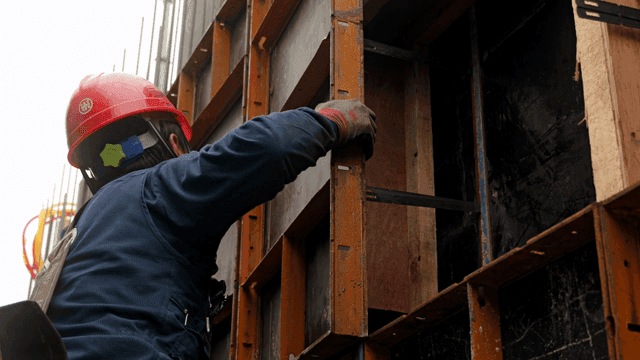 Construction worker assembling a framework