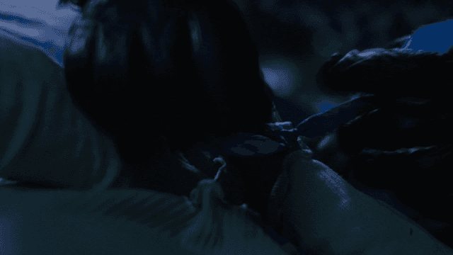 Man tying woman behind his back with rope