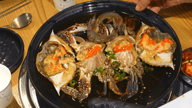 Table with Korean marinated crab dish