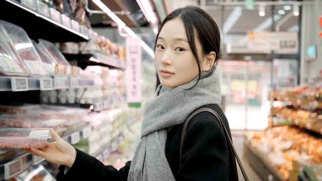 Young woman shopping for meat at grocery store