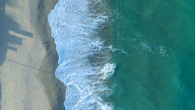 Ocean Waves Crashing along the Sandy Shore