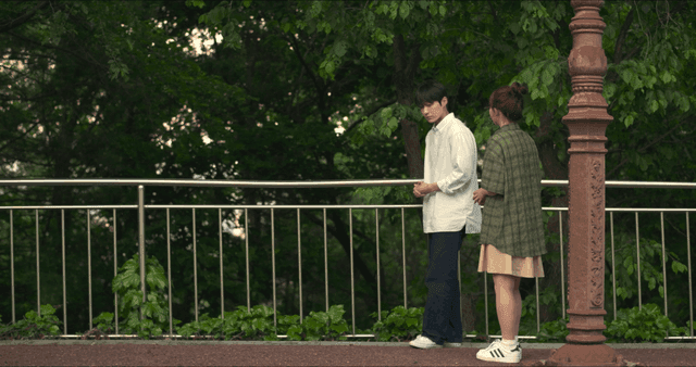 Man and woman stopping to talk while walking on street