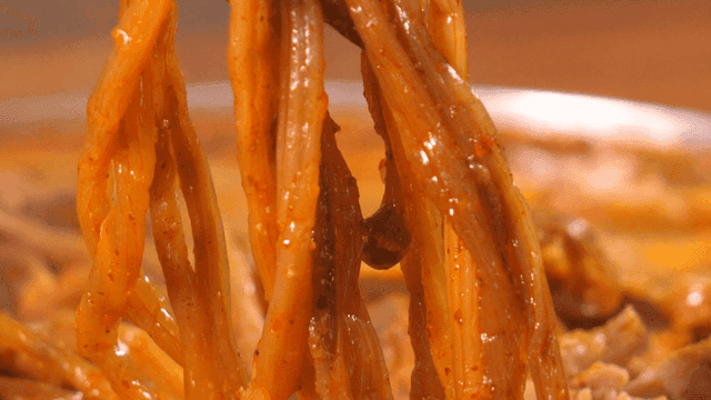 Sweet potato stems from pork backbone stew picked up with chopsticks