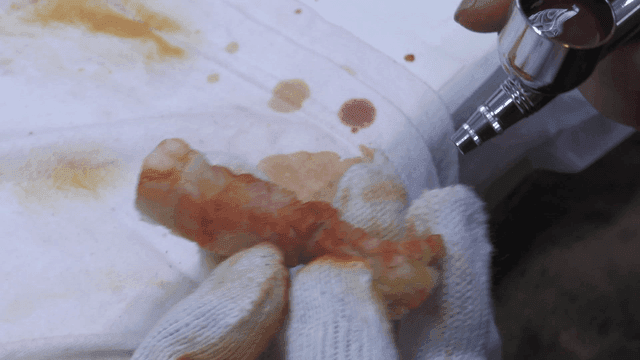 Craftsman using airbrush to paint pork belly model