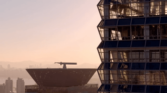 Modern skyscraper reflecting sunset