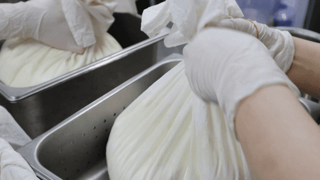 Yogurt wrapped with cloth in a kitchen
