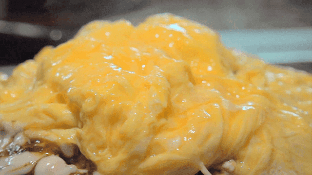 Okonomiyaki topped with a soft steaming omelet