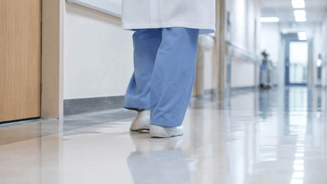 Doctor's shoes walking down hospital hallway