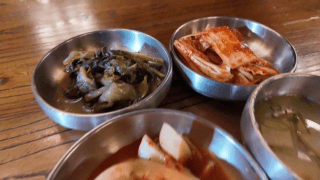 Various Korean side dishes on table