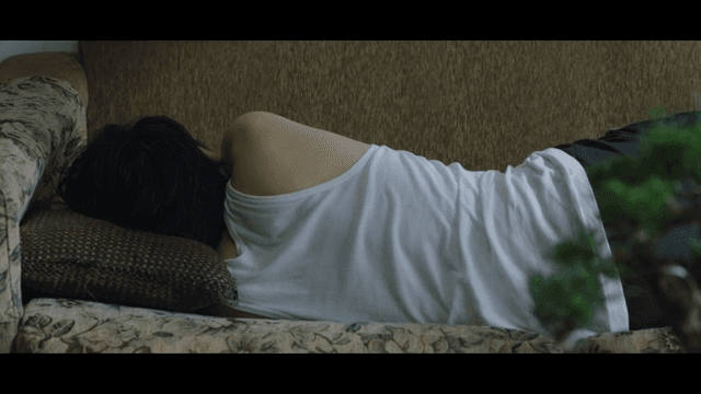 Person sleeping on a couch indoors