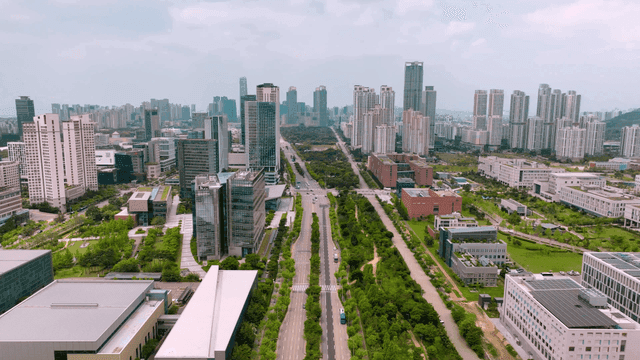 Modern cityscape with tall buildings and greenery