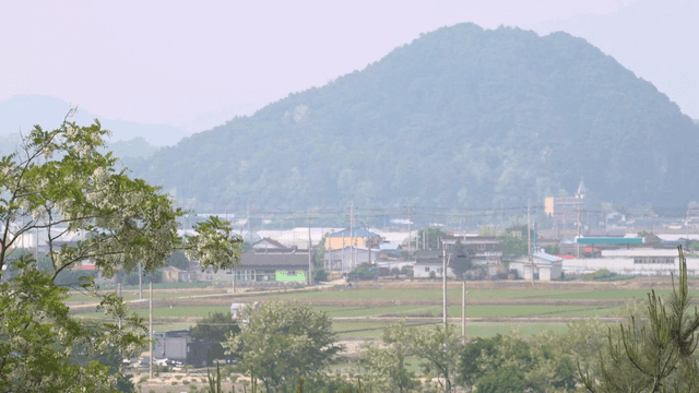 Peaceful rural village with mountains visible in distance