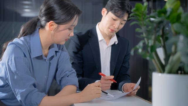 Two colleagues discussing documents