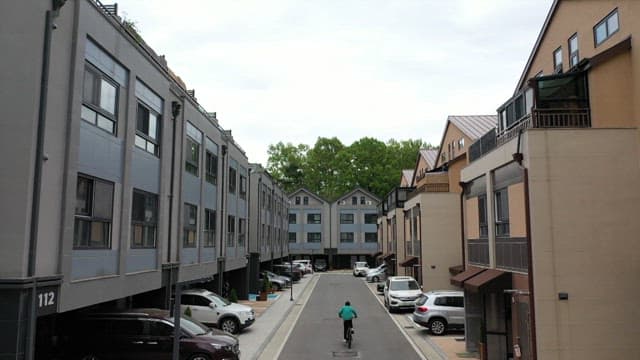A man riding a bicycle in the residential area