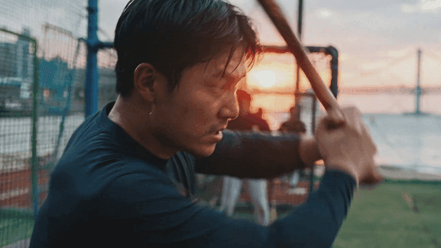 Baseball player practicing at sunset