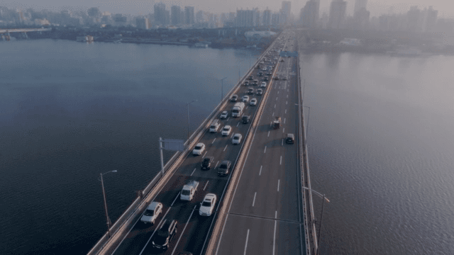 Bridge over a river with city skyline