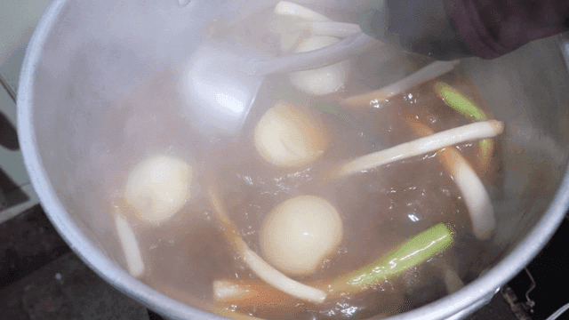 Rich soy sauce broth with green onions and onions