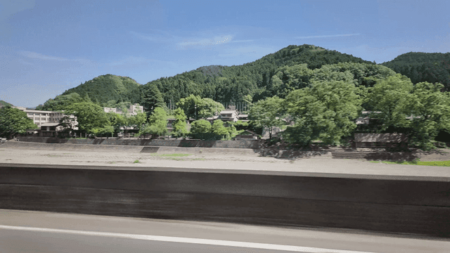 Road scenery with rural village and mountains