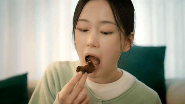 Woman eating Dubai chewy cookies at home