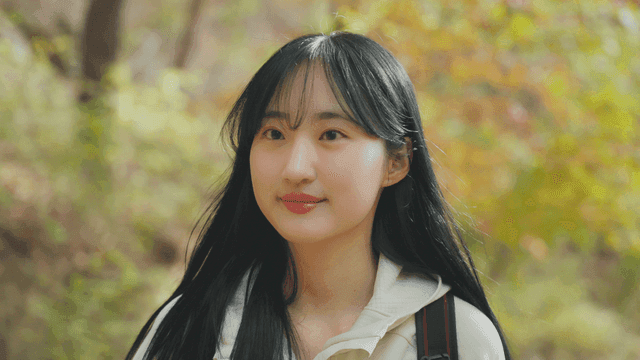 Young woman walking on colorful autumn trail
