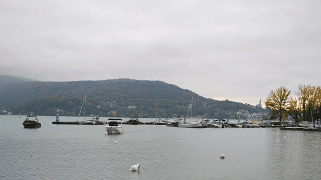 Peaceful lake with boats and hills