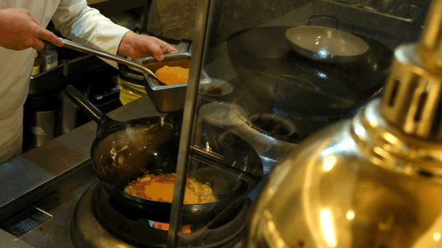 Chef preparing sauce in a kitchen