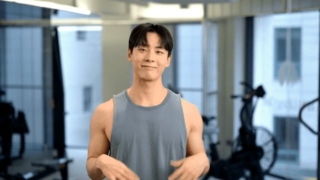 Young man warming up while shaking hands at gym