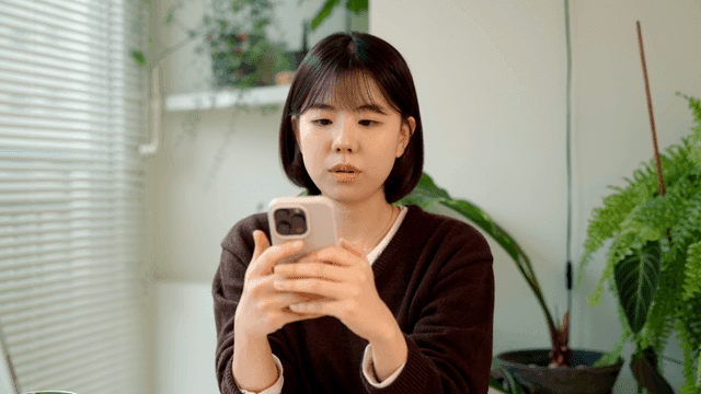 Young woman using smartphone at home