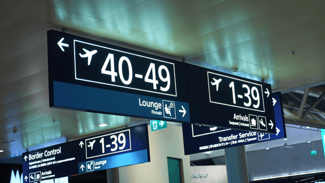 Airport signs indicating gates and services