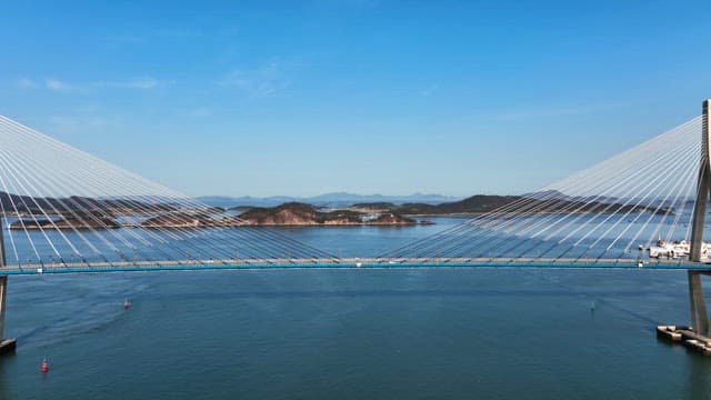 Bridge over a calm sea with distant islands