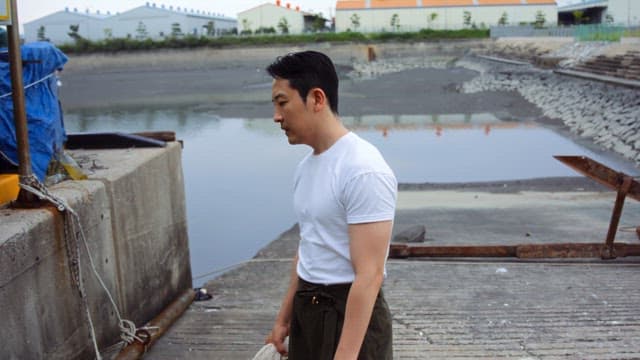 Man standing by the dockside sighing