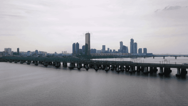 Bridge over river against backdrop of city skyline