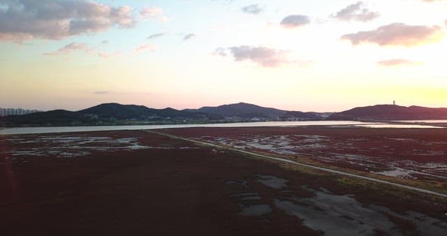 Tranquil sunset landscape with mountains and sea