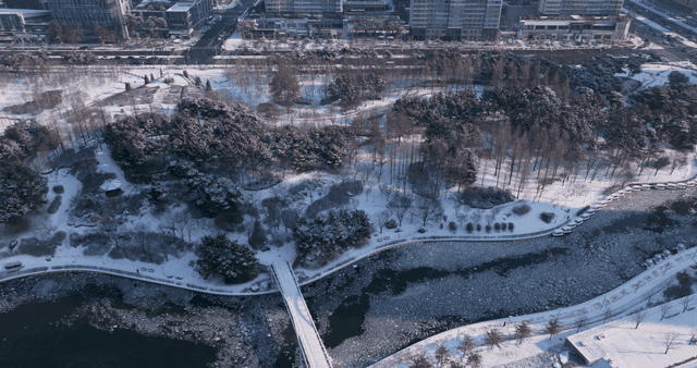 Snow-covered city park and roads
