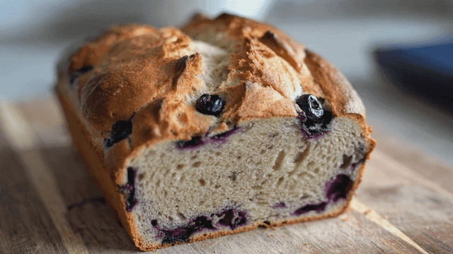 Freshly baked blueberry bread on a wooden board