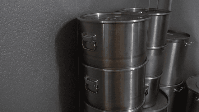 Metal pots stacked in storage room