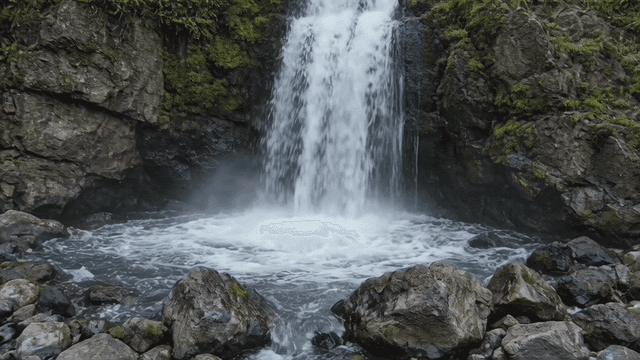 Waterfall falling along rocky cliff