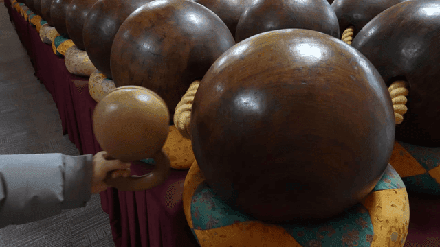 Wooden bell and giant prayer beads