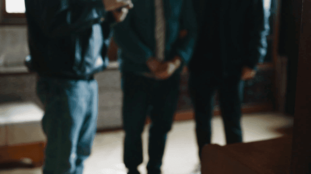 Back of woman looking at person arrested at scene