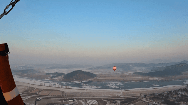 Hot air balloons above beautiful landscape