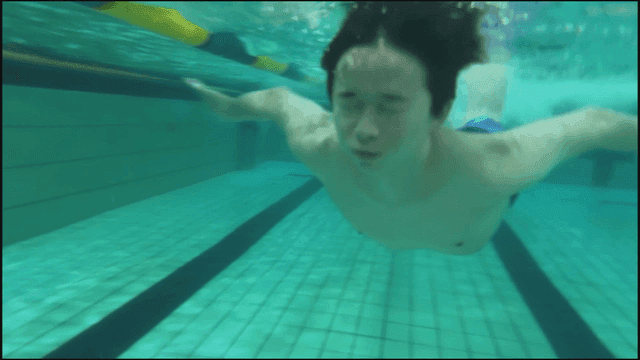 Man swimming with his eyes closed in pool